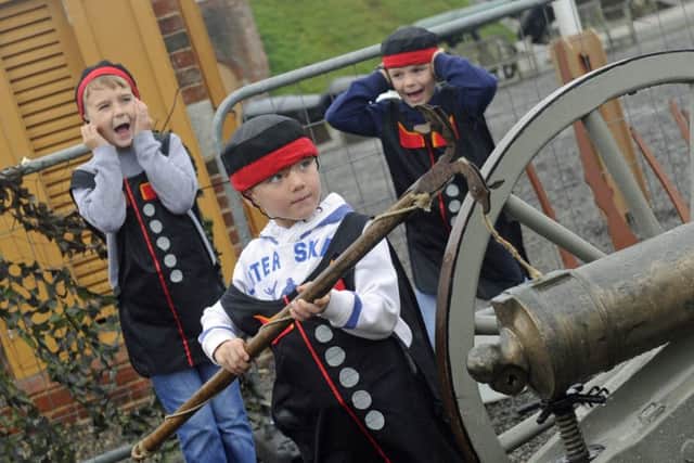 Children were invited to take part in a junior gun run at Fort Nelson. William Hardy (seven) loads the gun with (left), Ethan Kelly (eight), from Portsmouth and his brother Zachary (six). Picture: Ian Hargreaves (161223-1)