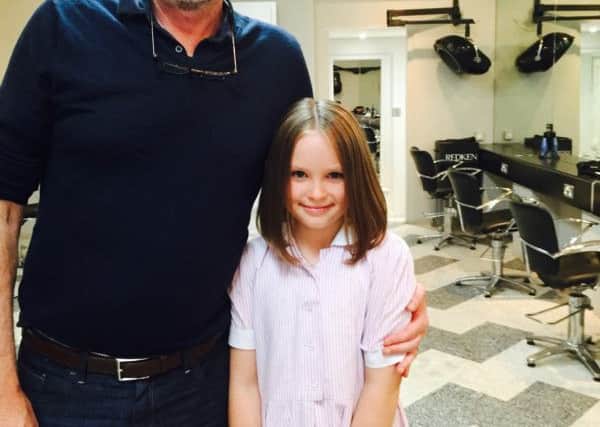 Lily Glew with hairdresser Jimmy Cronin who chopped off her long locks for charity