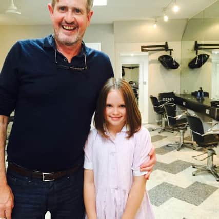 Lily Glew with hairdresser Jimmy Cronin who chopped off her long locks for charity
