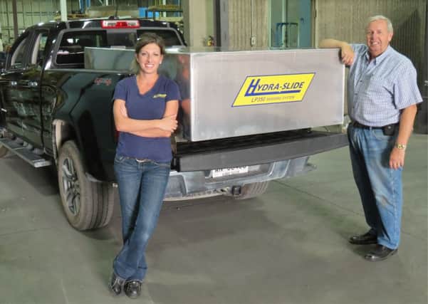 Don Mahnke, president and Janine Smith, vice president at Hydra-Slide,
 with a new LP350 being shipped to Rapid Response Solutions in Dundas Lane, Portsmouth