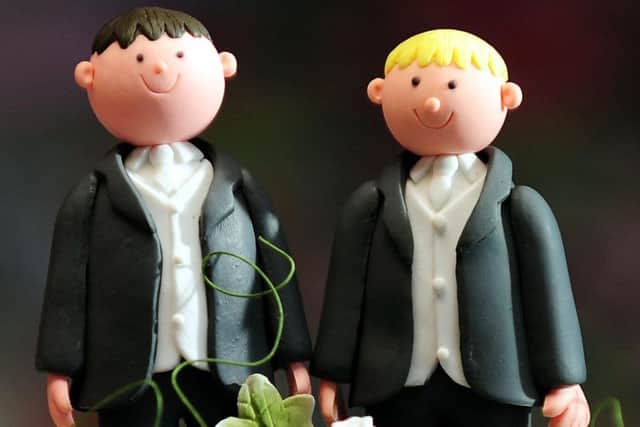 File photo dated 05/02/13 of groom cake decorations on a wedding cake as MPs prepare to debate the coalition's gay marriage legislation. PRESS ASSOCIATION Photo. Issue date: Monday May 20, 2013. See PA story COMMONS Gay. Photo credit should read: Rui Vieira/PA Wire ENGEMN00120130520085913