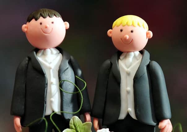 File photo dated 05/02/13 of groom cake decorations on a wedding cake as MPs prepare to debate the coalition's gay marriage legislation. PRESS ASSOCIATION Photo. Issue date: Monday May 20, 2013. See PA story COMMONS Gay. Photo credit should read: Rui Vieira/PA Wire ENGEMN00120130520085913