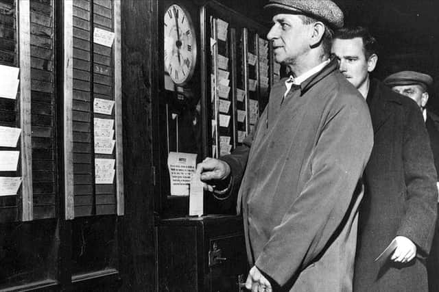 CLOCKWATCHING A worker waits for the clock to hit 6pm before clocking out