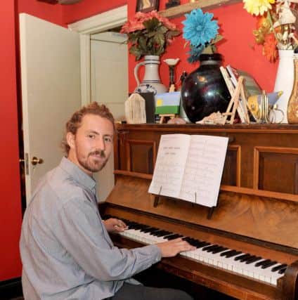 Arts Lodge volunteer Moses Milner (24) tinkles the ivories. Picture: Sarah Standing (161256-6361)