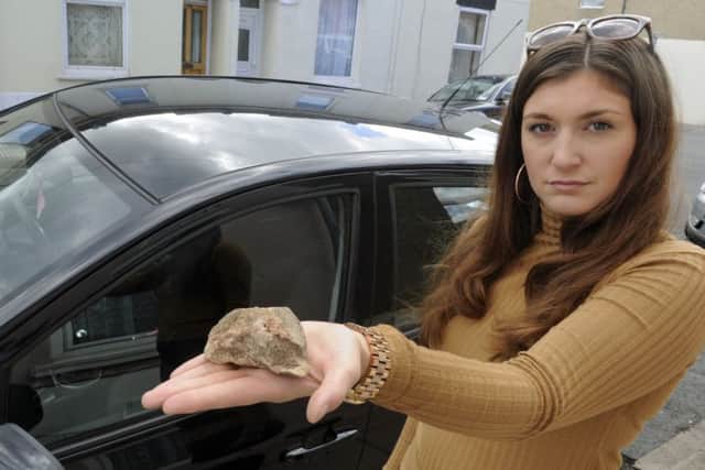 Grace Rushmere with the piee of concrete that was thrown at her car as she drove