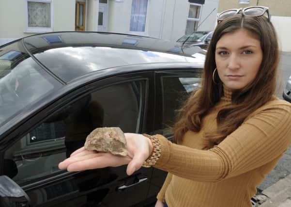 Grace Rushmere with the piee of concrete that was thrown at her car as she drove