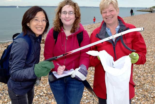 From the left are Asuka Kayeura, 28, of London, Amy Griffiths, 21, of Southampton, and Sara Coombes, 59, of Emsworth. They were part of the team of volunteers helping to clean Southsea beach on Saturday	 Picture: Tom Cotterill