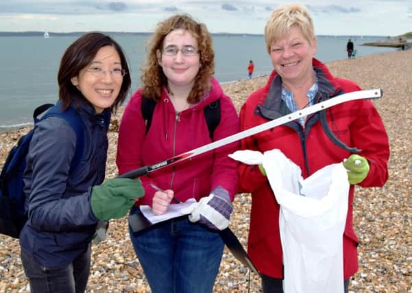 From the left are Asuka Kayeura, 28, of London, Amy Griffiths, 21, of Southampton, and Sara Coombes, 59, of Emsworth. They were part of the team of volunteers helping to clean Southsea beach on Saturday	 Picture: Tom Cotterill