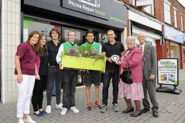 Paul Traill, owner of The Mobile Phone Repair Doctor in London Road Waterlooville, and staff receive an award from the Mayoress of Havant Cllr Faith Ponsonby and her husband Michael