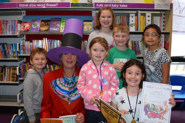 From the left are eager readers Joshua Bull, seven, volunteer Sarah Allen as Willy Wonka, Ellie Bull, four (middle), Erin Coffey, nine, Quinn Coffey, six, Olivia Barker, eight and Audrey Peralta, seven Picture: Loughlan Campbell