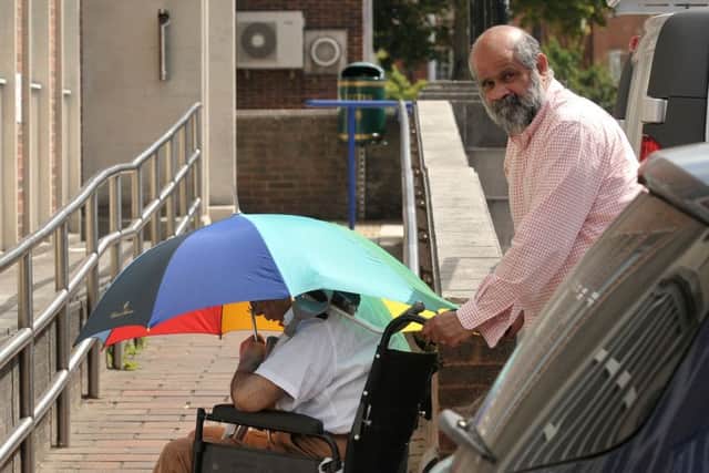 Robin Correa pushes a wheelchair-user whose blue badge parking permit he fraudulently used