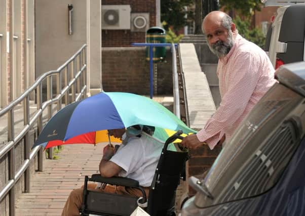 Robin Correa pushes a wheelchair-user whose blue badge parking permit he fraudulently used