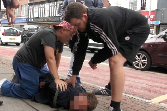 A man was pinned to the ground outside Poundland in North End after allegedly trying to steal sweets today Picture: Habibur Rahman