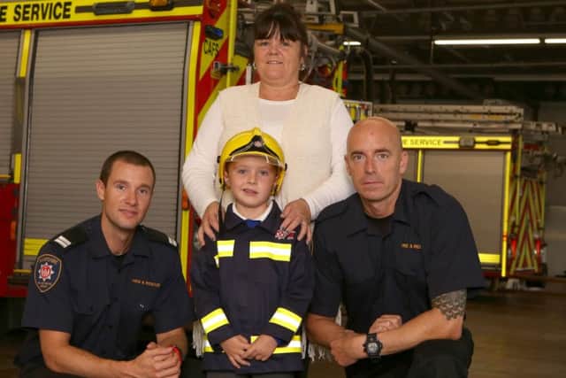 Frances Crouch with firefighters Rich Furse and Mark Hair and her grandson Jack Whitmore, six Picture: Habibur Rahman (161321-30)