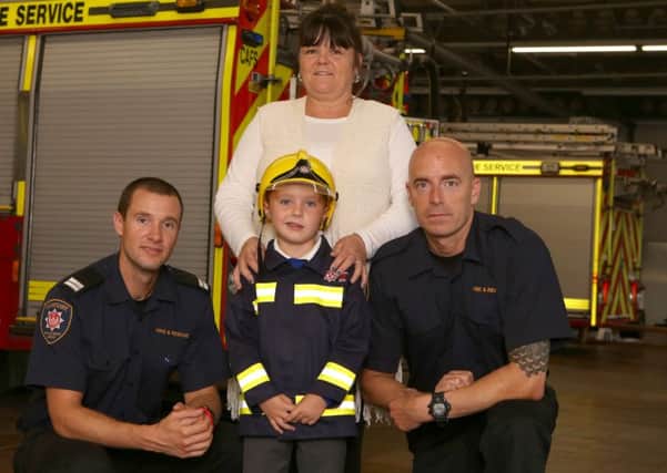 Frances Crouch with firefighters Rich Furse and Mark Hair and her grandson Jack Whitmore, six Picture: Habibur Rahman (161321-30)