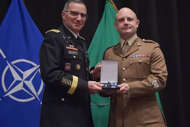 Neil Donaghy, right, being presented with his Nato Meritorious Medal