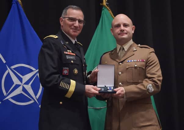 Neil Donaghy, right, being presented with his Nato Meritorious Medal