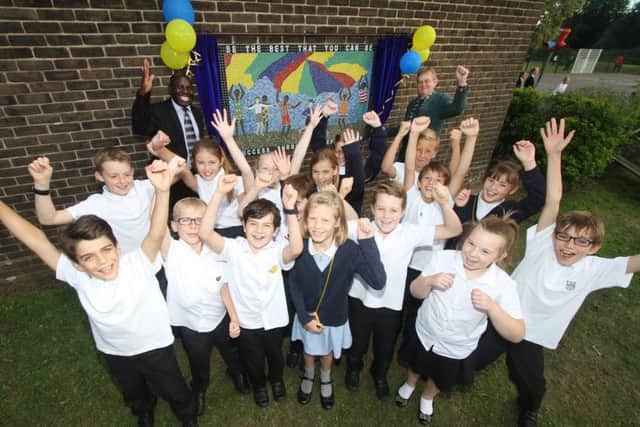 Co-founders Charles Etoru and Steve Peach unveil the mosaic in front of a mixture of Year 4, 5 and 6 pupils at Clanfield Junior School Picture: Habibur Rahman (161327-69)