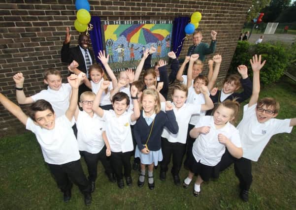 Co-founders Charles Etoru and Steve Peach unveil the mosaic in front of a mixture of Year 4, 5 and 6 pupils at Clanfield Junior School Picture: Habibur Rahman (161327-69)