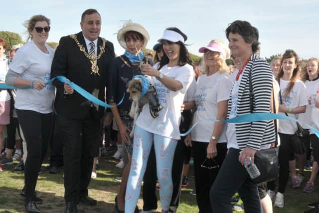 EastEnders actor Emma Barton and Poppy cut the ribbon to start the Alzheimers Memory Walk with from left, Penny Mordaunt MP, Lord Mayor David Fuller, Lady Mayoress Leza Tremorin, and Flick Drummond MP Picture: Mick Young (161153-02)