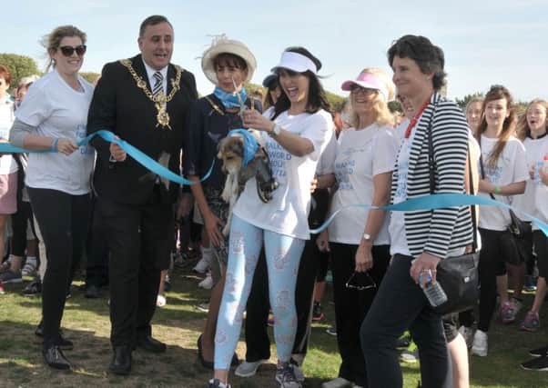 EastEnders actor Emma Barton and Poppy cut the ribbon to start the Alzheimers Memory Walk with from left, Penny Mordaunt MP, Lord Mayor David Fuller, Lady Mayoress Leza Tremorin, and Flick Drummond MP Picture: Mick Young (161153-02)