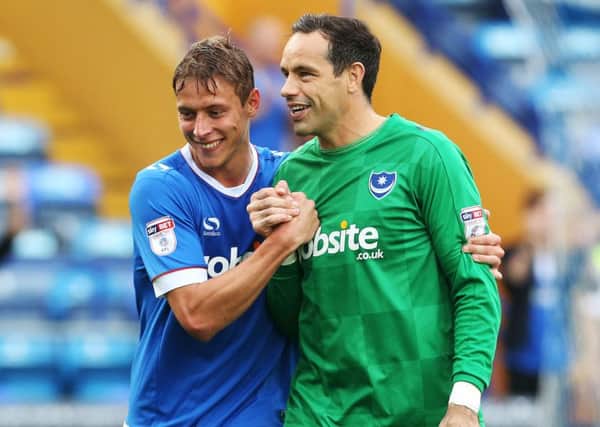 Tom Davies, left, with Pompey keeper David Forde after the 5-1 win against Barnet on Saturday Picture: Joe Pepler