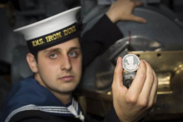 AB Alex Sadiris with the coin in front of the gun Jack Cornwell VC used at the Imperial War Museum