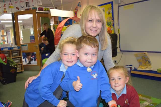Mikey Strachan, four, with his sisters Skye, five, left, Mika, seven, and mum Chevonne Newlands, at Crofton Anne Dale Infant School in StubbingtonPicture: Loughlan Campbell
