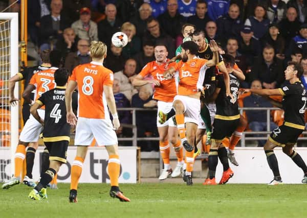 Kelvin Mellor, centre, heads Blackpool in front in their 3-1 win over Pompey at Bloomfield Road      Picture: Joe Pepler