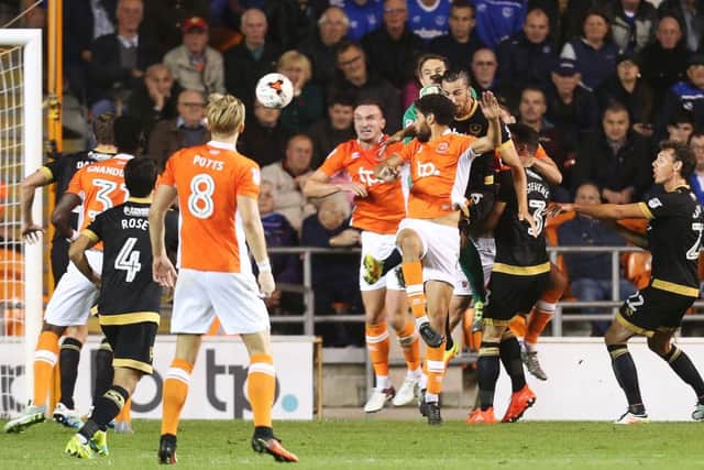 Kelvin Mellor, centre, heads Blackpool in front in their 3-1 win over Pompey at Bloomfield Road      Picture: Joe Pepler