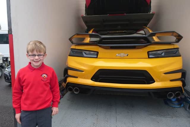 Layton Bradley, six, got a sneak preview of the set of Transformers 5 after his dad Gez, 31, took him to the film set at the Royal Navy Submarine Museum in Gosport early on Thursday morning. Layton is pictured with the Bumblebee car used in the film, voiced by actor Mark Ryan