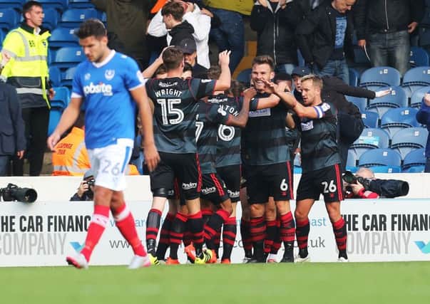 Doncaster players celebrate after taking the lead at Fratton Park. Picture: Joe Pepler