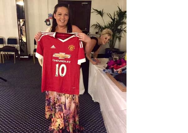 Janine Taylor with a signed Man United shirt at the bras and pants auction