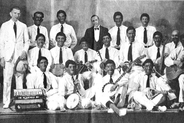 A curious picture of the banjor mandolin and guitar club in which most of the men look like the Black and White Minstrels - a photo which would not be taken today