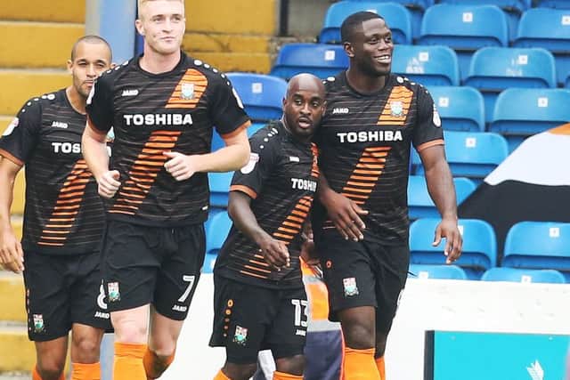 John Akinde celebrates scoring from the penalty sport for Barnet at Fratton Park Picture: Joe Pepler