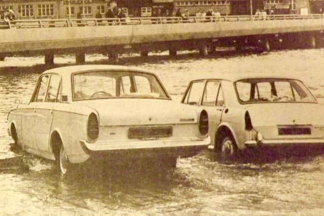 OOPS! Two cars about to be overcome by the tide on the slipway at The Hard, Portsea, in 1970. The new approach road from The Hard to the Harbour station is at the top