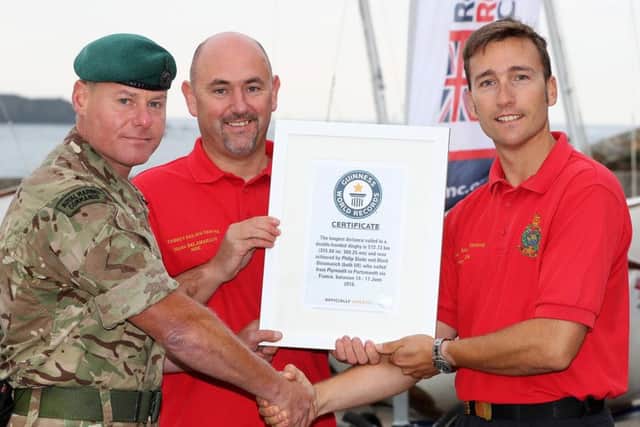PO Phil Slade, right, and Mark Belarmaich, centre, were presented their Guinness World Record Certificate by Major Steve O'Sullivan