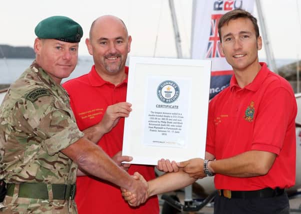 PO Phil Slade, right, and Mark Belarmaich, centre, were presented their Guinness World Record Certificate by Major Steve O'Sullivan