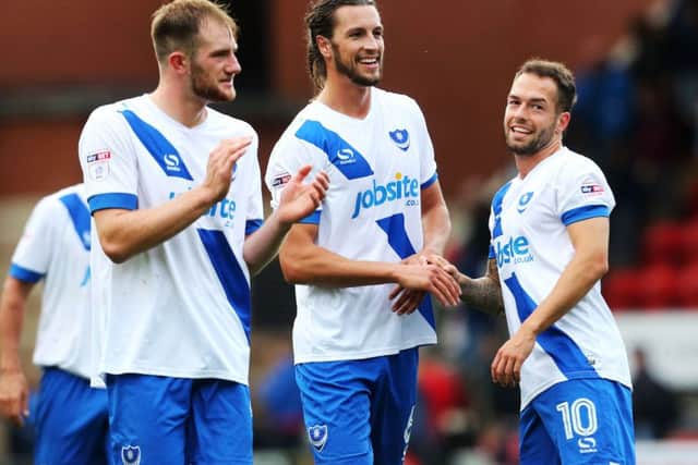 Pompey goal-hero Christian Burgess, centre, with Matt Clarke, left, and Milan Lalkovic. Picture: Joe Pepler