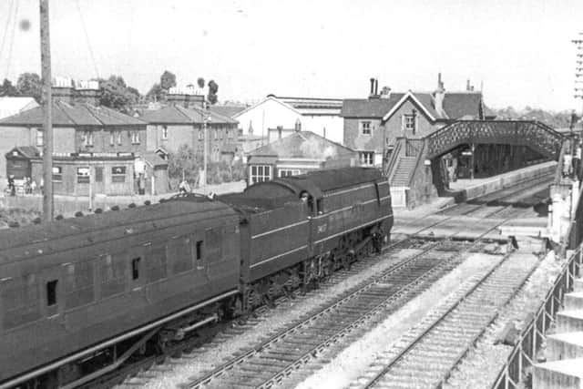 Passing Cosham signal box in 1950 we see a West Country/Battle of Britain class locomotive at the head of a train from the west.