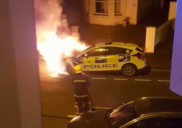 ARSON: Firefighters battle to extinguish a blazing police car torched by arsonists in Gosport. PHOTO:  Terri Wilson