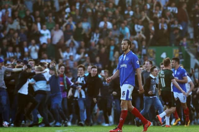 Christian Burgess looks on dejected while Plymouth celebrate. Picture: Joe Pepler