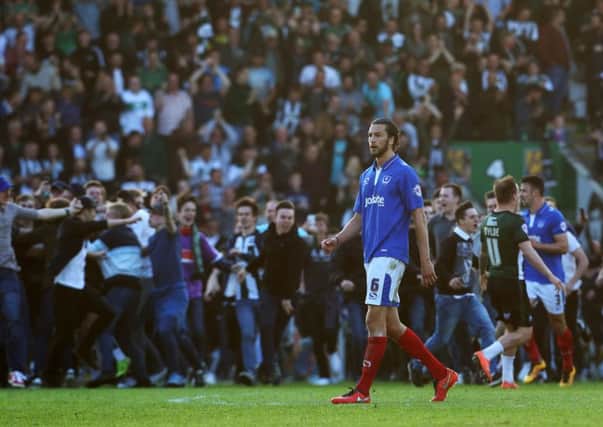 Christian Burgess looks on dejected while Plymouth celebrate. Picture: Joe Pepler