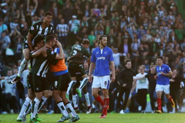 Christian Burgess trudges off the Home Park pitch as Plymouth celebrate their League Two play-off semi-final victory last season. Picture: Joe Pepler