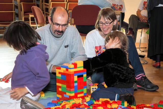 Student minister Julie Minter, right, helping families with their Lego constructions at Build@Church