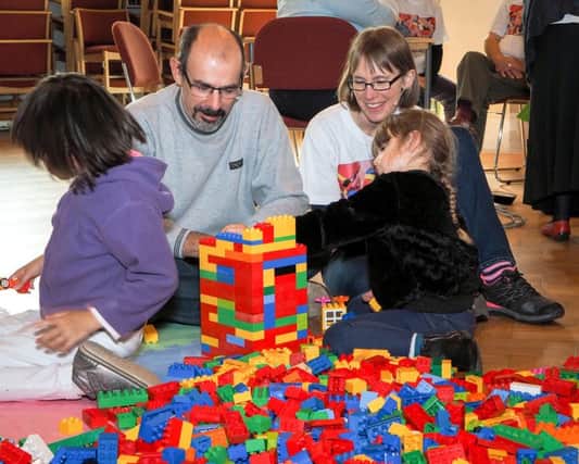 Student minister Julie Minter, right, helping families with their Lego constructions at Build@Church