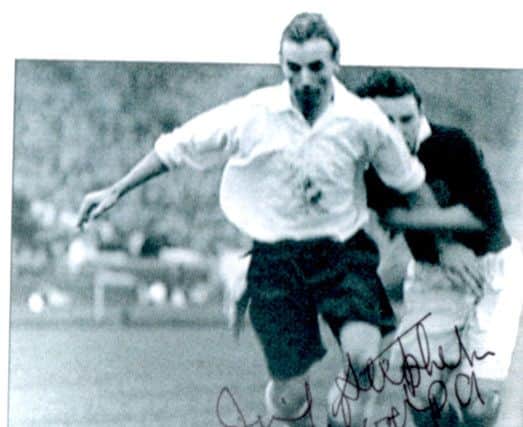 The photo that Jimmy hated, grabbing the arm of Stanley Matthews in a wartime international at Wembley in 1944.