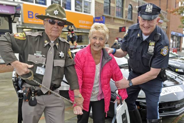 American police enthusiasts Garry Walton and Martyn Calder 'arrest' shopper Gwen Samphille                Picture: Ian Hargreaves (161263-2)