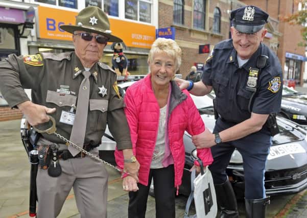 American police enthusiasts Garry Walton and Martyn Calder 'arrest' shopper Gwen Samphille                
Picture: Ian Hargreaves (161263-2)