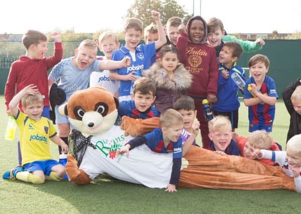 Children with Rowan the meerkat at the football pitches outside the Roko gym    Picture: Habibur Rahman